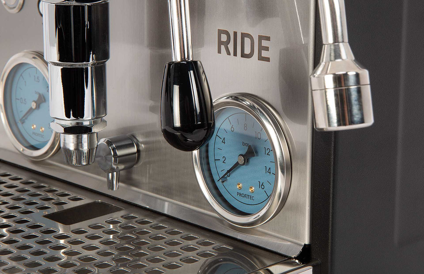 Close-up of a coffee machine with 'RIDE' branding and pressure gauges.