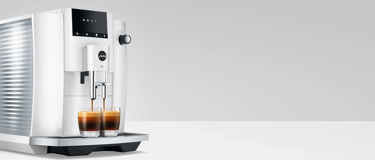 White coffee machine with two cups of coffee on a white background