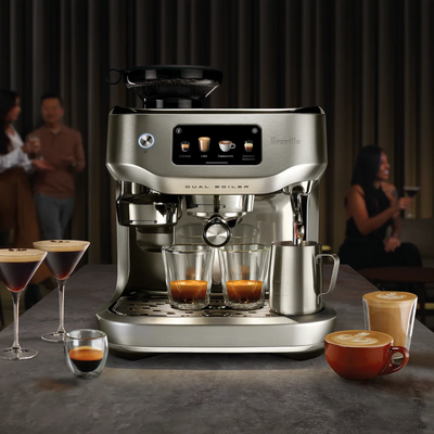 Breville coffee machine with various coffee beverages on a table