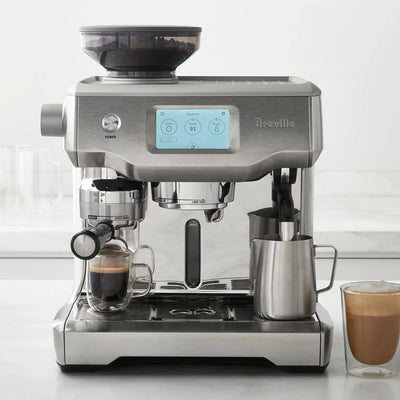 Breville coffee machine with two glasses of coffee on a white surface