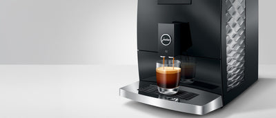 Jura C3 coffee machine with a glass of coffee on a white background