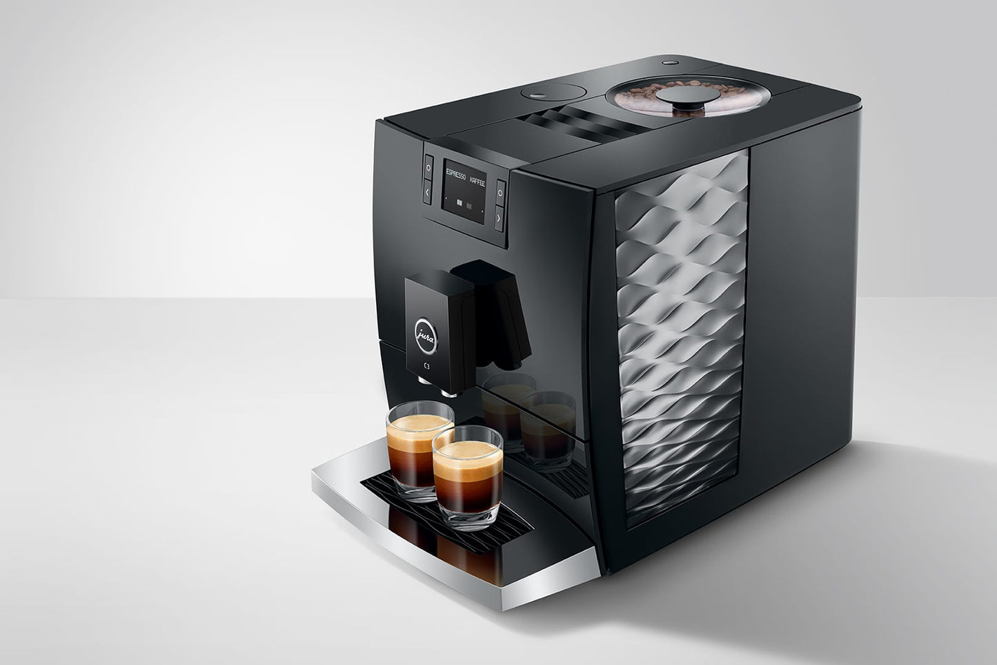 Black Jura C3 coffee machine with two cups of coffee on a white background