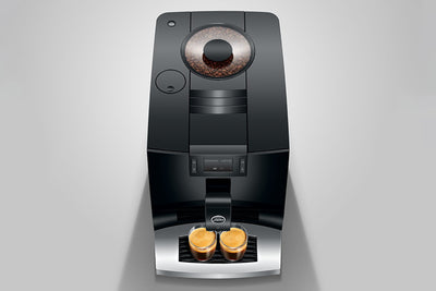 Modern coffee machine with two coffee pods on a gray background