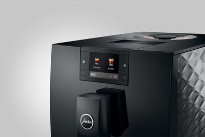 Black coffee machine with digital display on a gray background