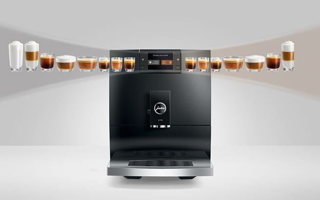 Modern coffee machine with various coffee beverages displayed around it on a white background