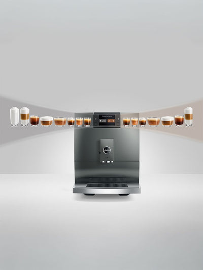 Stainless steel coffee machine with multiple cups of coffee on a white background