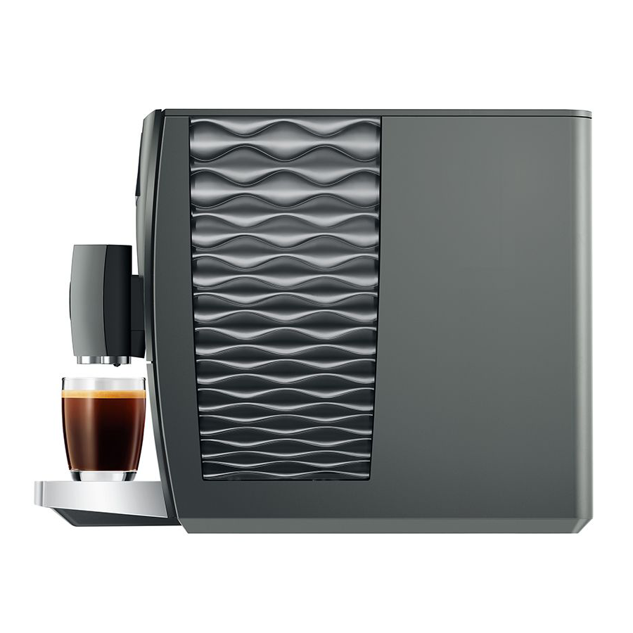 Gray coffee machine with a glass of coffee on a white background