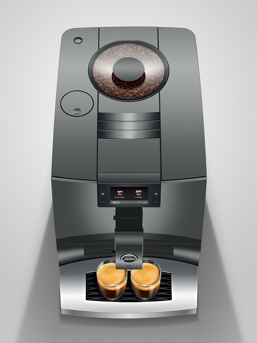coffee machine with two freshly brewed cups on a light gray background