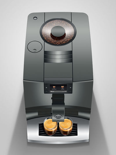 coffee machine with two freshly brewed cups on a light gray background