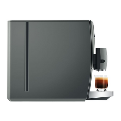 Gray coffee machine with a glass of coffee on a white background