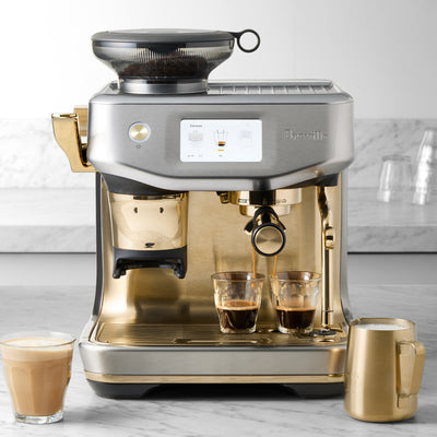 Breville coffee machine with two cups of coffee on a marble countertop