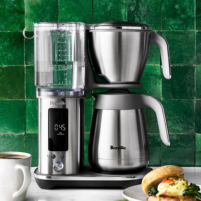 Breville - The Luxe Brewer Drip Coffee Maker - BDC415BSS / BDC465BSS with digital display on a kitchen counter with a green tiled wall background.