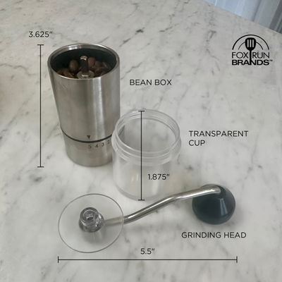 A coffee grinder set shown on a white marble surface with overlaid dimension lines and labels identifying the bean box, transparent cup, and grinding head. The bean box contains coffee beans.