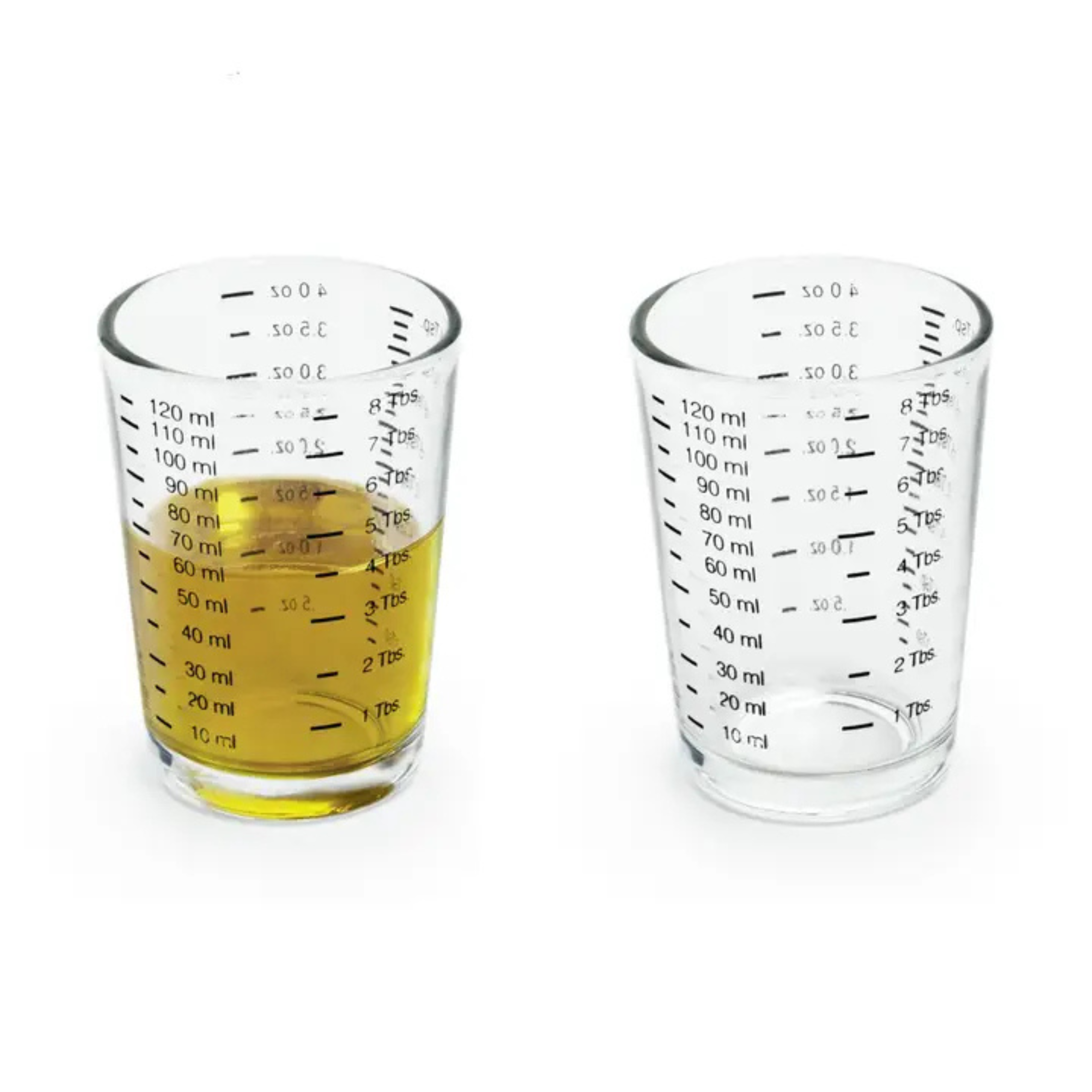 two shot glasses side by side with one filled with yellow liquid.