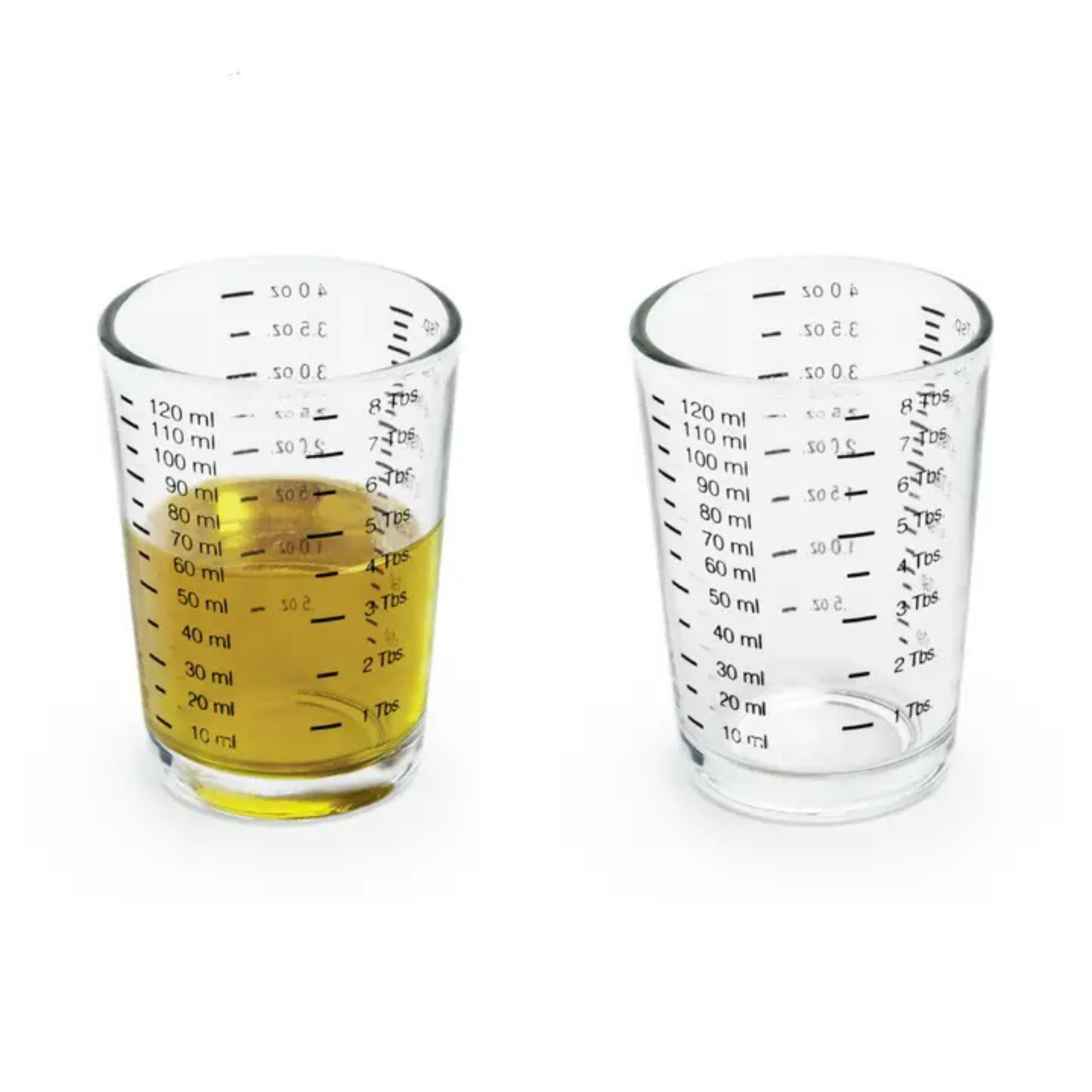 two shot glasses side by side with one filled with yellow liquid.
