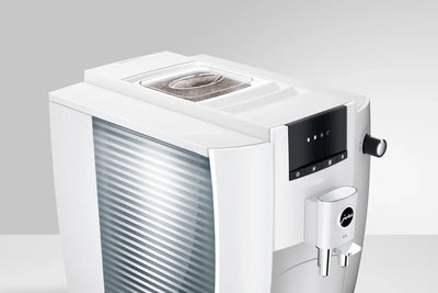 White coffee machine with digital display on a light gray background