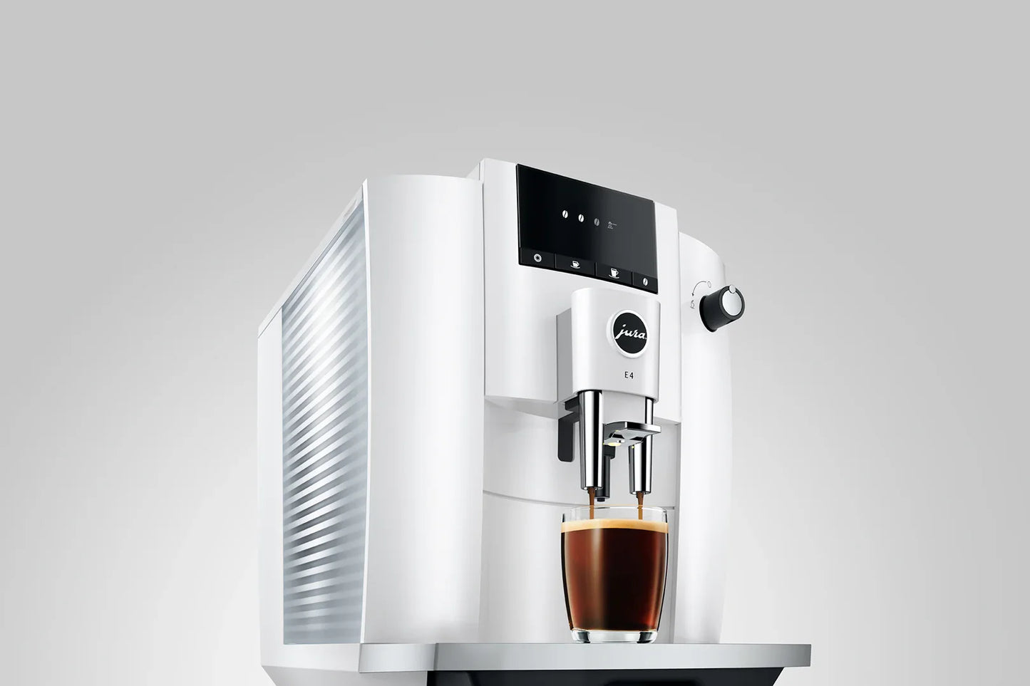 White coffee machine with a glass of coffee on a gray background