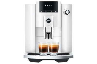 White coffee machine with two glasses of coffee on a white background