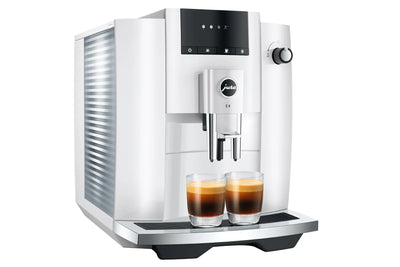 White coffee machine with two glasses of coffee on a white background