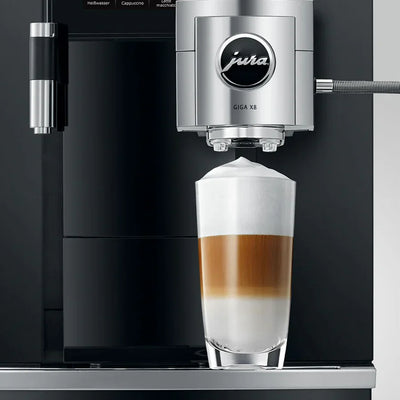 Jura coffee machine dispensing a layered coffee drink into a glass.