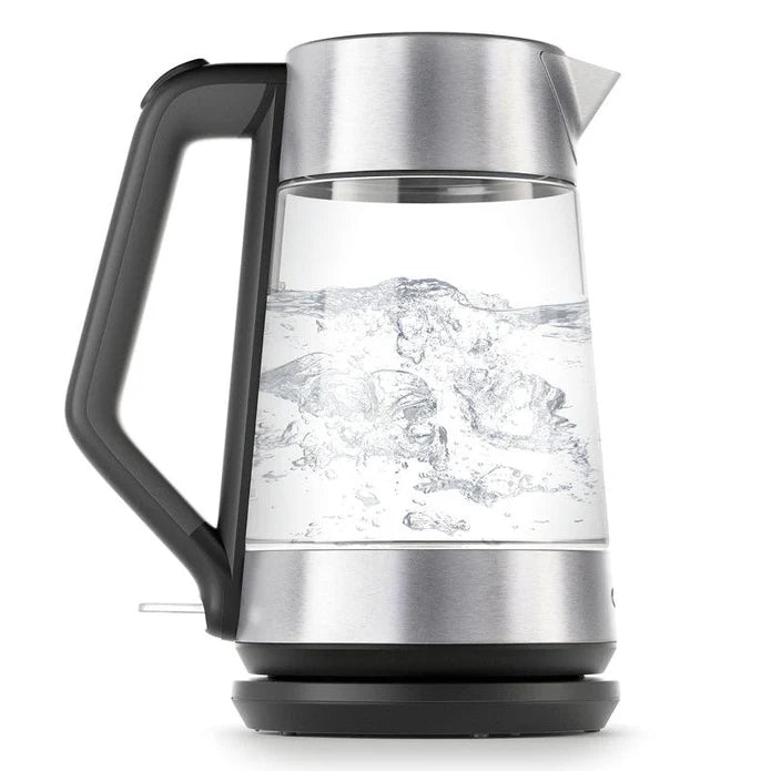 Glass electric kettle with boiling water on a white background