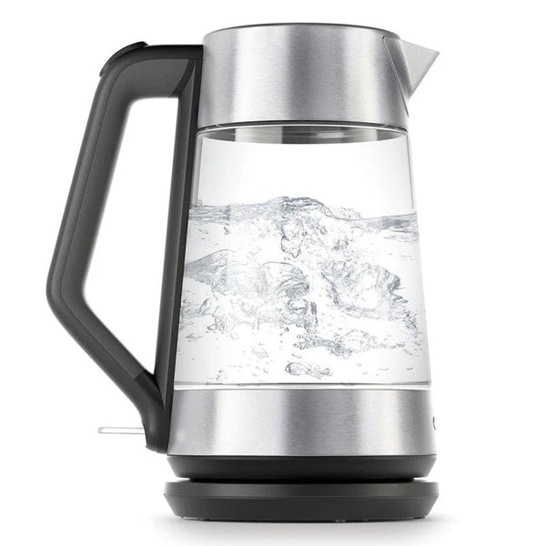 Glass electric kettle with boiling water on a white background