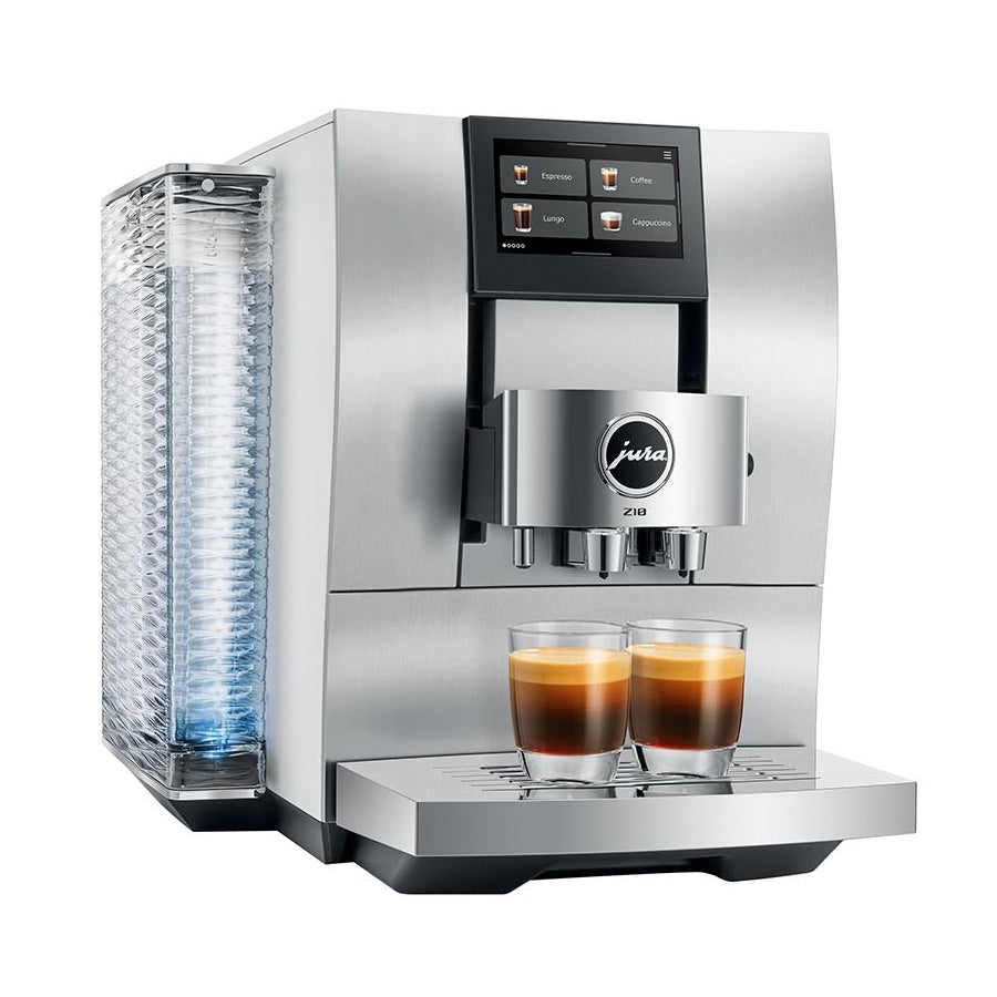 A Jura ESAM coffee machine in stainless steel with a digital touch screen, a water tank on the left, and two glasses of espresso on the drip tray, shown against a solid white background.