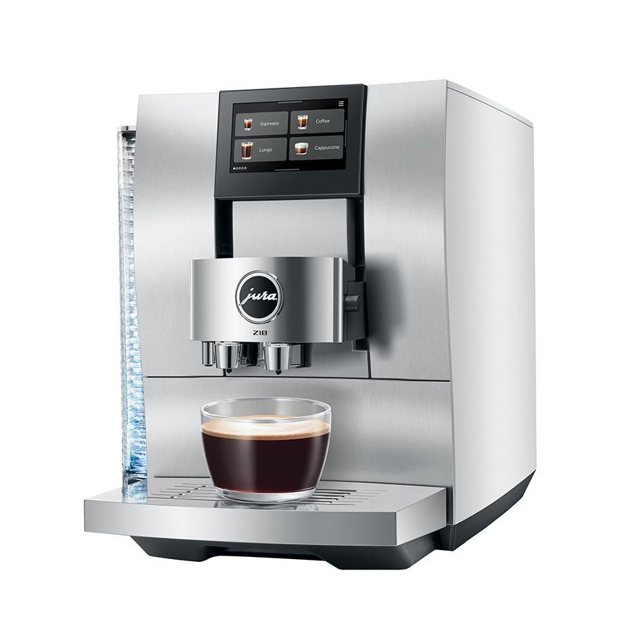 A stainless steel Jura ESpresso coffee machine with a digital touch screen, shown with a glass of espresso on its drip tray against a white background.